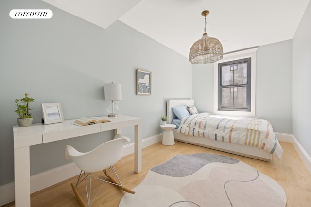 bedroom with baseboards, light wood-style flooring, and visible vents