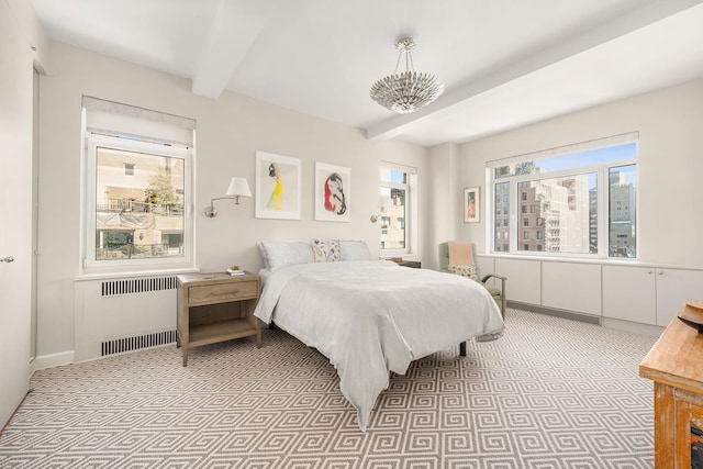 bedroom with radiator, multiple windows, beamed ceiling, and baseboards