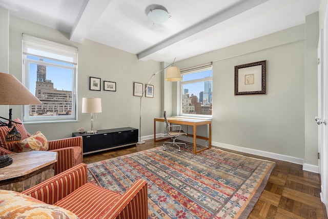875 5th Ave Unit 12Ef, New York City, NY 10065 - living area with beamed ceiling, a skyline view, baseboards, and an office area