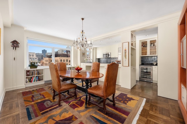 dining space featuring beverage cooler, a view of city, and an inviting chandelier