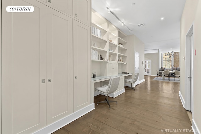 hall featuring baseboards, visible vents, rail lighting, and dark wood-style floors
