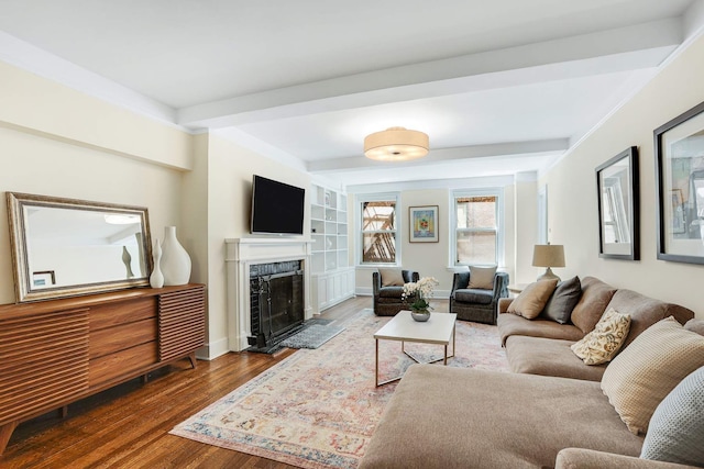 434 E 52nd St Unit 6D, New York City, NY 10022 - living room featuring baseboards, beam ceiling, a high end fireplace, built in shelves, and wood finished floors