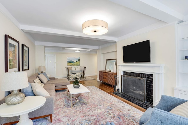 434 E 52nd St Unit 6D, New York City, NY 10022 - living area featuring beamed ceiling, baseboards, wood finished floors, and a fireplace with flush hearth