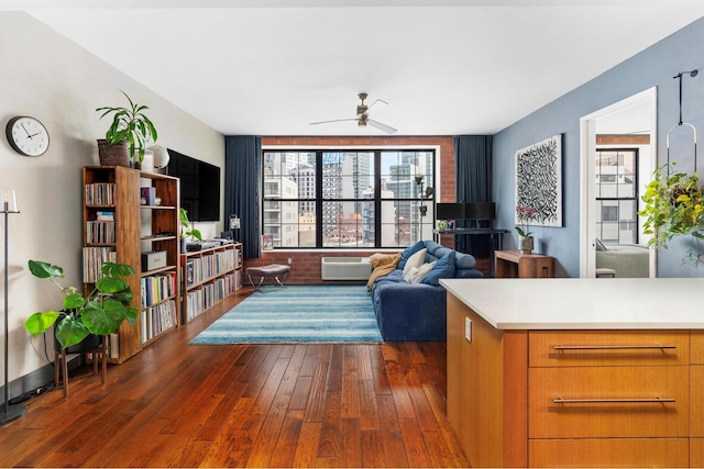 42-60 Crescent St Unit 7D, New York City, NY 11101 - living area featuring plenty of natural light, ceiling fan, an AC wall unit, and dark wood-style floors