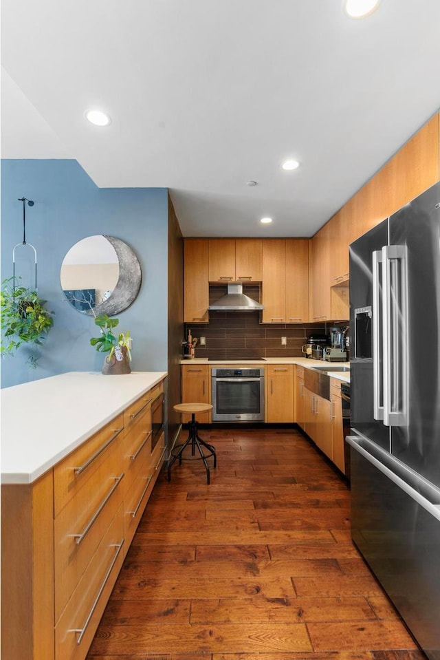 42-60 Crescent St Unit 7D, New York City, NY 11101 - kitchen with decorative backsplash, appliances with stainless steel finishes, range hood, dark wood finished floors, and light countertops
