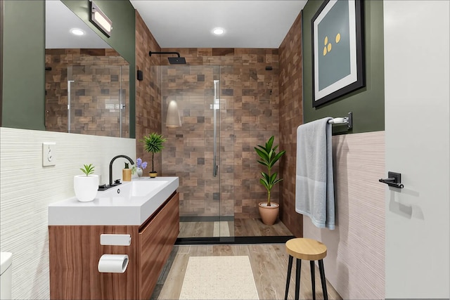 42-60 Crescent St Unit 7D, New York City, NY 11101 - full bathroom with vanity, a stall shower, recessed lighting, and tile walls