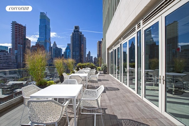 301 E 61st Street Penthouse, New York City, NY 10065 - view of patio with outdoor dining area and a view of skyline