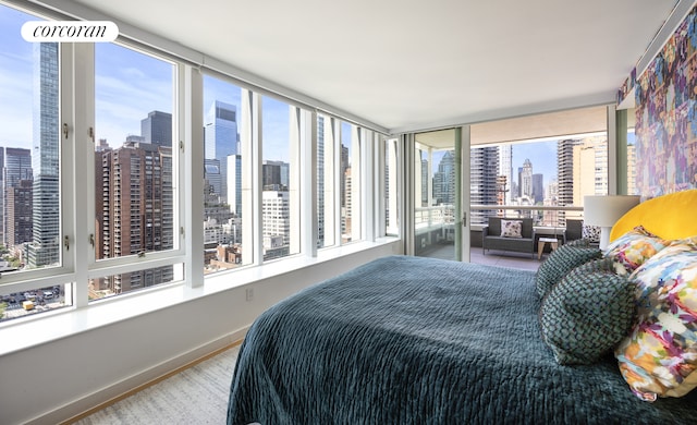 301 E 61st Street Penthouse, New York City, NY 10065 - bedroom with a skyline view and baseboards