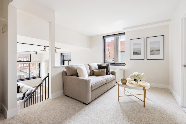 carpeted living room with plenty of natural light and baseboards