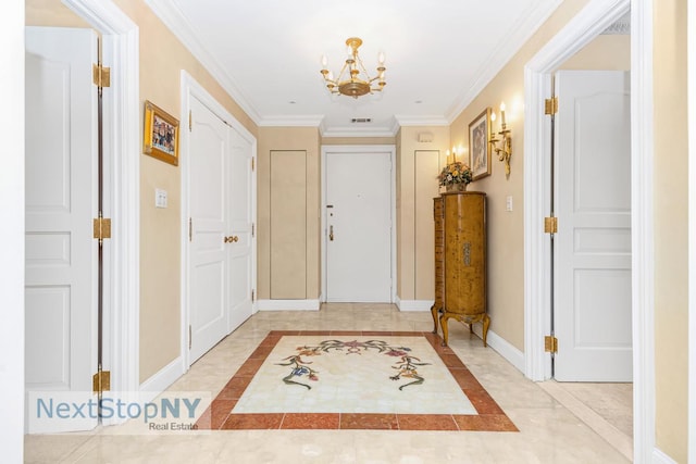 entrance foyer with crown molding, visible vents, baseboards, and a chandelier