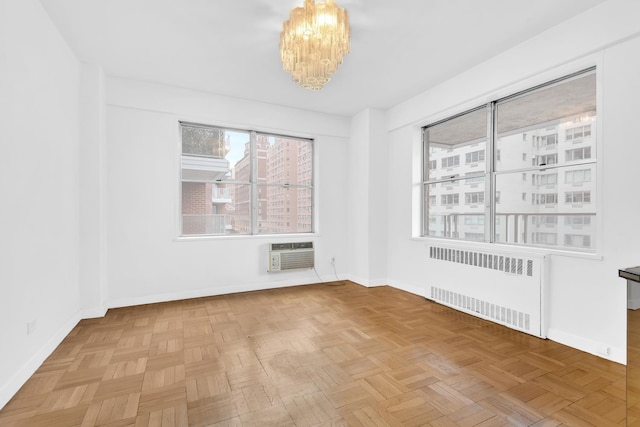 50 Sutton Pl S Unit 8H, New York City, NY 10022 - spare room featuring radiator heating unit, a wall mounted AC, and a chandelier