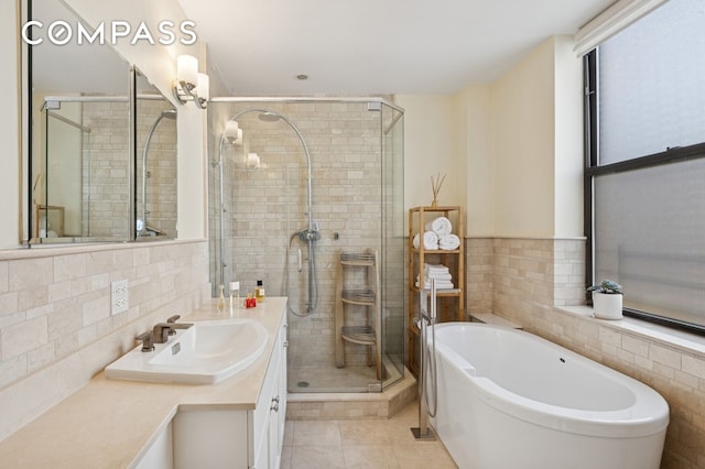514 W End Ave Unit 8/9A, New York City, NY 10024 - full bath featuring tile walls, a bathtub, vanity, a stall shower, and tile patterned floors