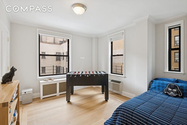 514 W End Ave Unit 8/9A, New York City, NY 10024 - bedroom featuring light wood finished floors, radiator heating unit, multiple windows, crown molding, and baseboards