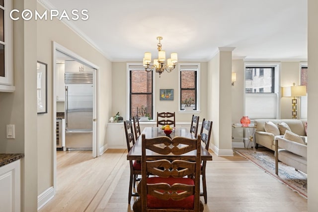 514 W End Ave Unit 8/9A, New York City, NY 10024 - dining space featuring light wood finished floors, a chandelier, plenty of natural light, and crown molding