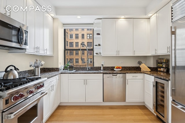 514 W End Ave Unit 8/9A, New York City, NY 10024 - kitchen with premium appliances, wine cooler, recessed lighting, white cabinets, and open shelves