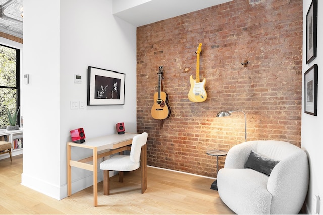 242 Lafayette St Unit 2N, New York City, NY 10012 - office space featuring brick wall, wood finished floors, and baseboards