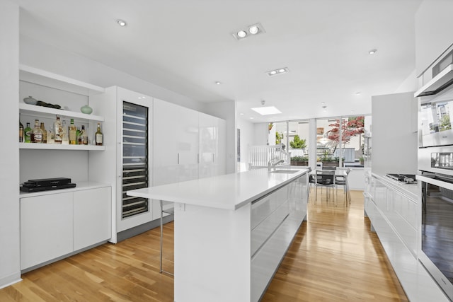 kitchen featuring a wealth of natural light, light wood-style floors, modern cabinets, and stainless steel appliances