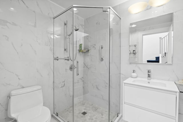 full bath featuring toilet, a marble finish shower, vanity, and tile walls