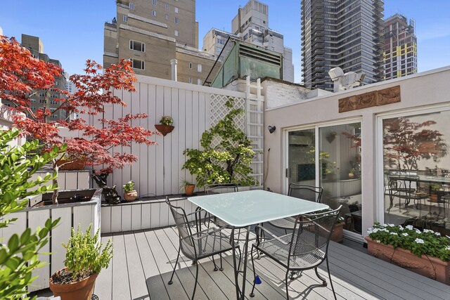 wooden deck featuring outdoor dining space