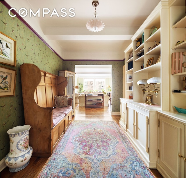 sitting room featuring wallpapered walls and wood finished floors