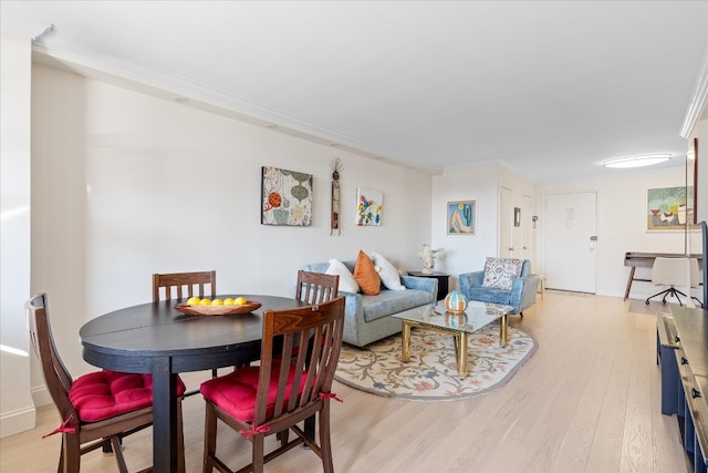 living room with light wood-style floors and ornamental molding