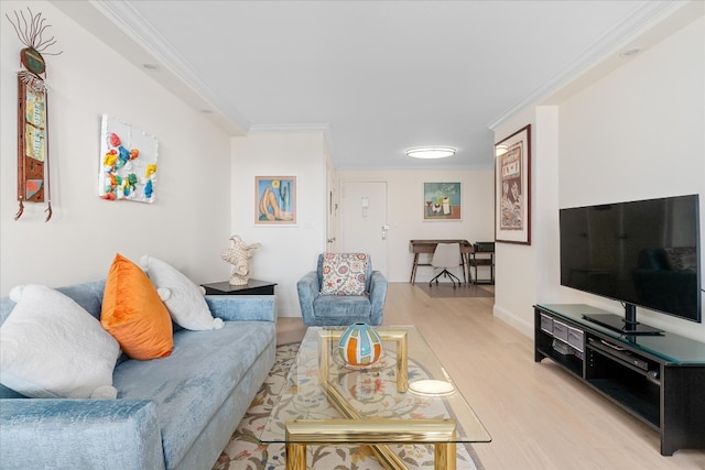 living room featuring baseboards, ornamental molding, and light wood-type flooring