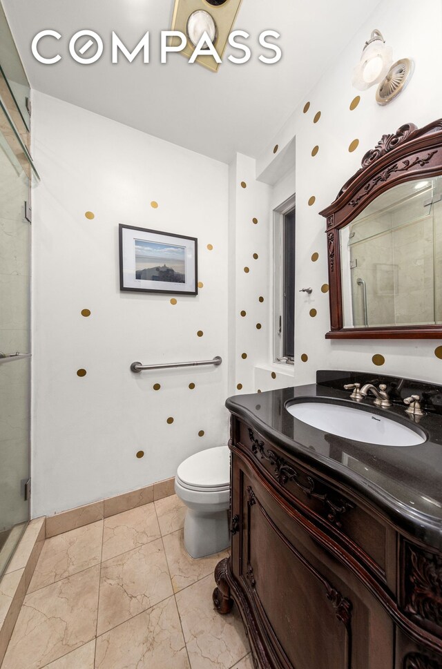517 E 87th St Unit 1, New York City, NY 10128 - bathroom featuring vanity, a shower stall, and marble finish flooring