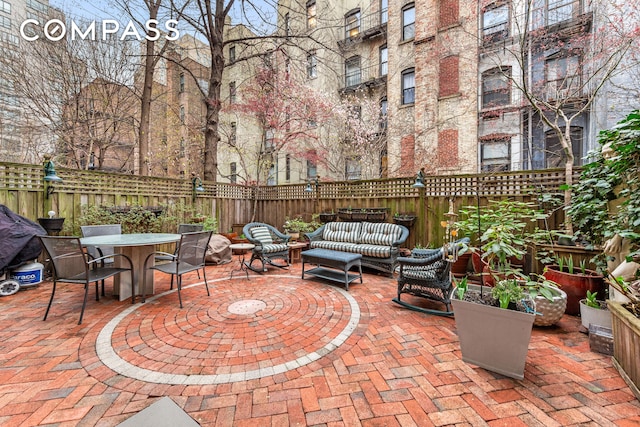 517 E 87th St Unit 1, New York City, NY 10128 - fenced backyard with a patio area, outdoor dining space, and outdoor lounge area