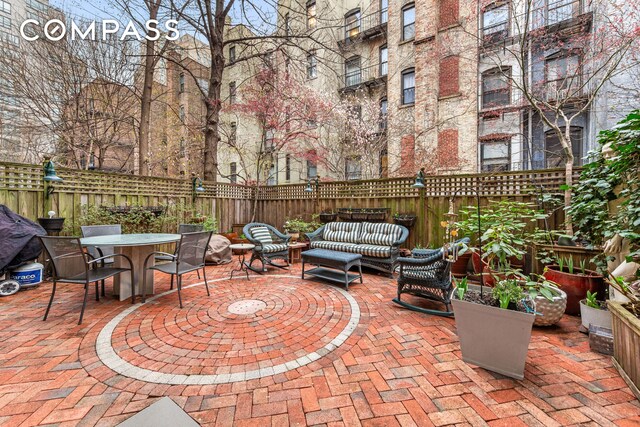 517 E 87th St Unit 1, New York City, NY 10128 - fenced backyard featuring a patio area, outdoor dining area, and an outdoor living space