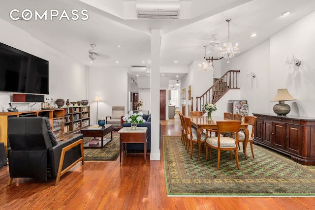 517 E 87th St Unit 1, New York City, NY 10128 - dining area with stairs, wood finished floors, a wall mounted air conditioner, and recessed lighting