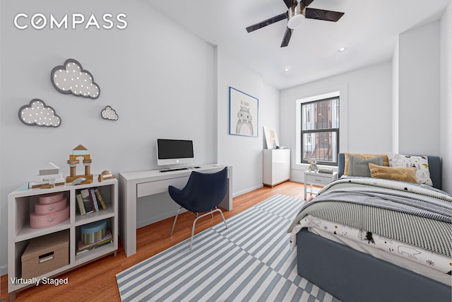 517 E 87th St Unit 1, New York City, NY 10128 - bedroom with wood finished floors, an office area, baseboards, and ceiling fan