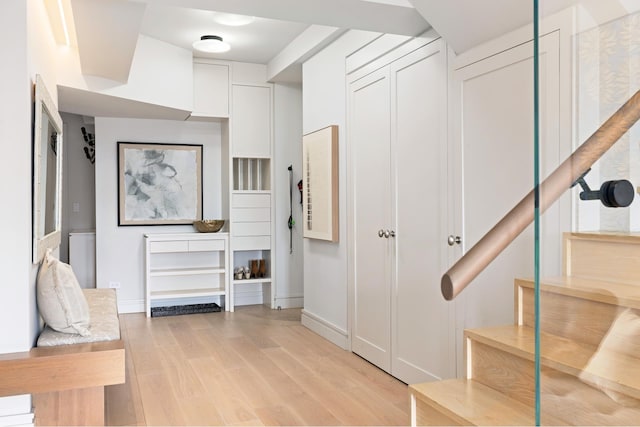 interior space with baseboards and light wood-style floors