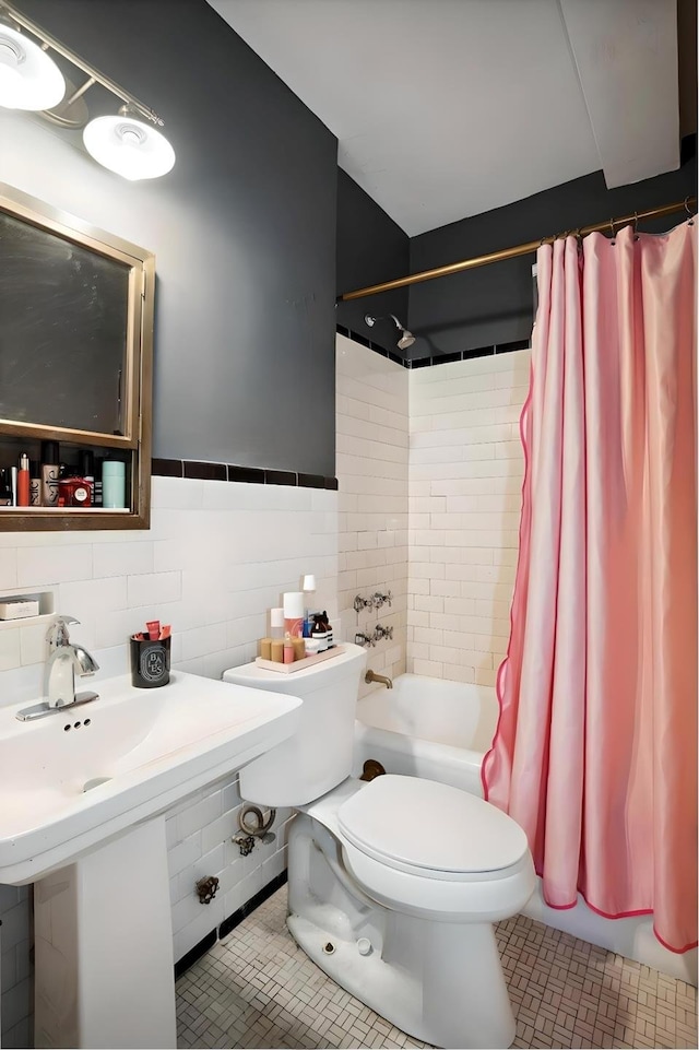 full bath featuring tile walls, tile patterned floors, shower / tub combo with curtain, and toilet
