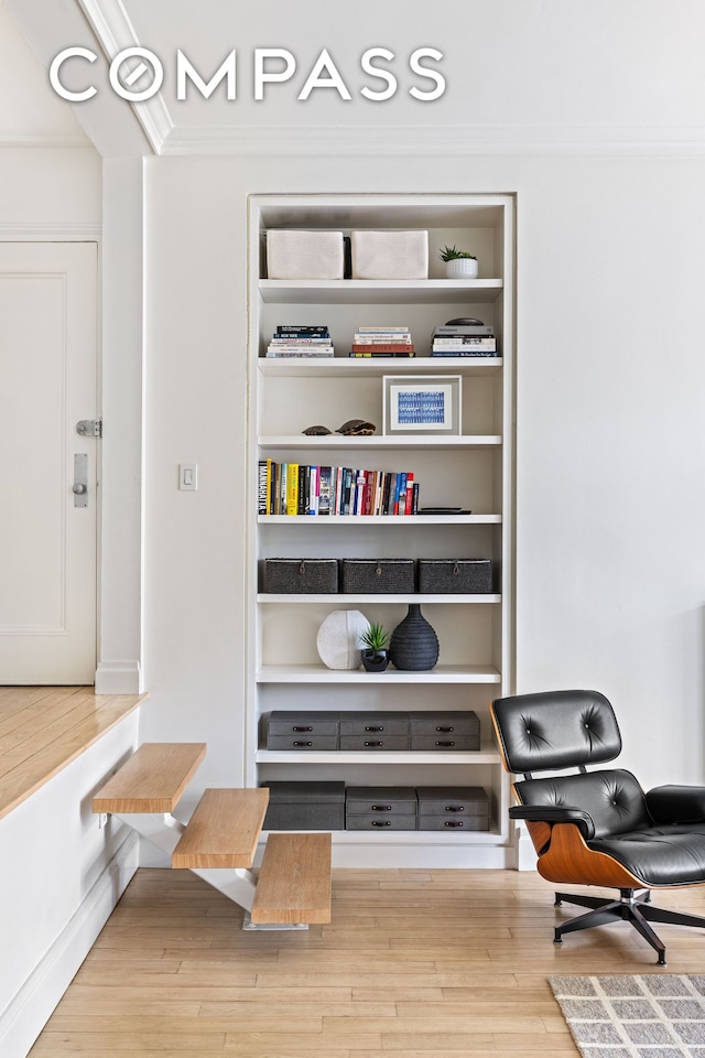 interior space featuring crown molding and wood finished floors
