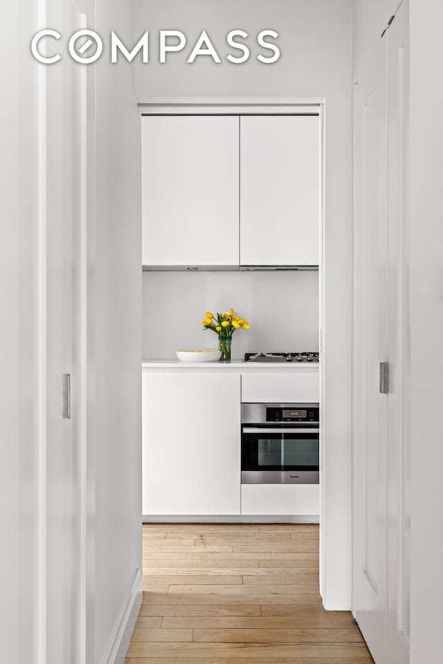 interior space with baseboards and hardwood / wood-style floors