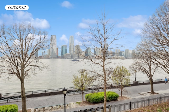 property view of water with fence and a view of city