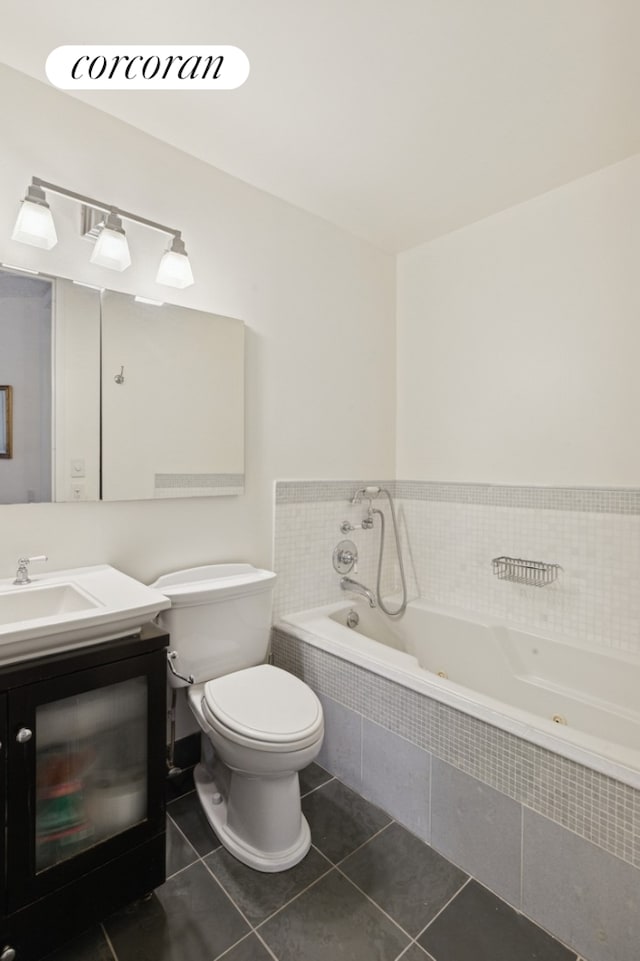 bathroom with toilet, tile patterned flooring, a garden tub, and vanity