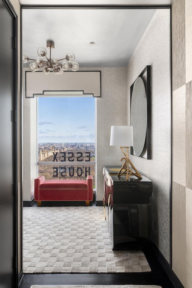 hall featuring carpet floors and a chandelier
