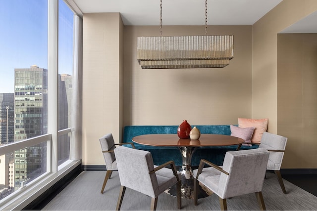 dining space with a view of city and baseboards