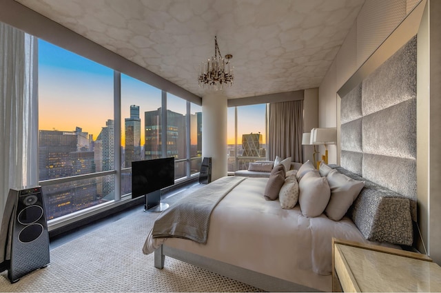 bedroom with carpet floors and a chandelier