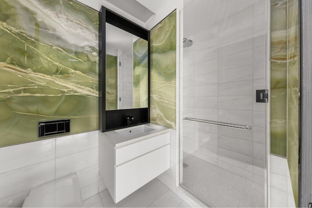 full bathroom featuring tile patterned floors, a shower stall, and vanity