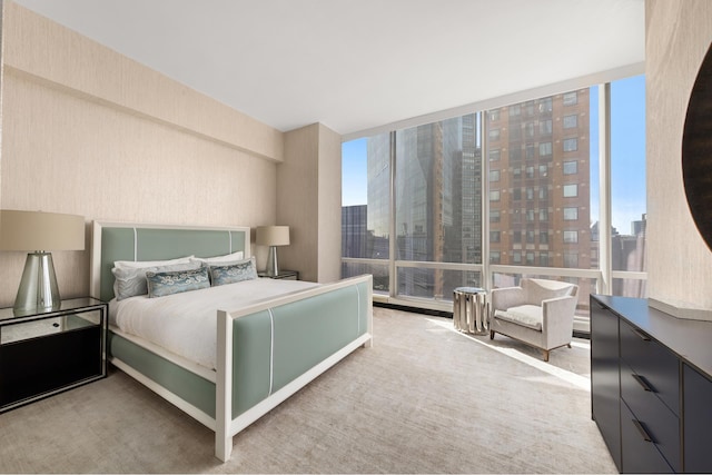 bedroom with a view of city and a wall of windows
