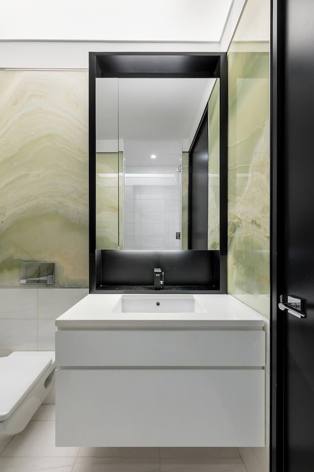 bathroom featuring vanity, tile patterned floors, and toilet