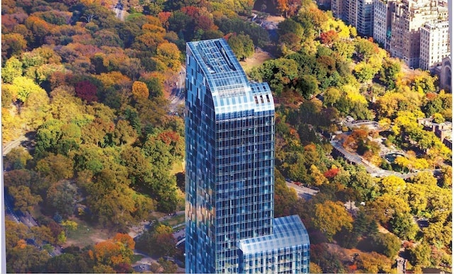 birds eye view of property featuring a view of trees and a city view