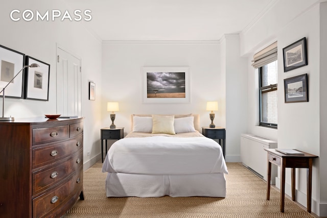 201 E 21st St Unit 12M, New York City, NY 10010 - bedroom featuring light carpet, crown molding, and baseboards