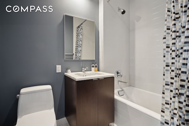 full bath featuring toilet, vanity, and tiled shower / bath combo