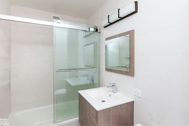 bathroom featuring a shower stall and vanity