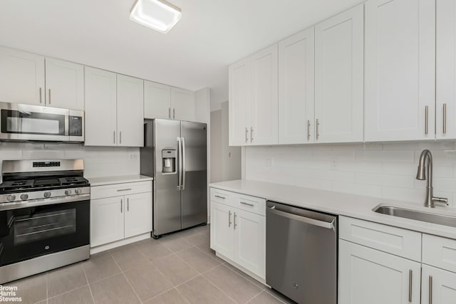 3333 Henry Hudson Pkwy Unit 19Y, New York City, NY 10463 - kitchen featuring appliances with stainless steel finishes, a sink, decorative backsplash, light countertops, and white cabinetry