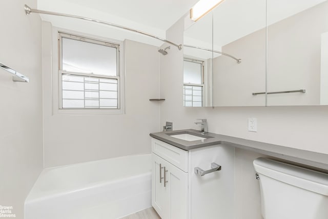 bathroom with toilet, tub / shower combination, and vanity