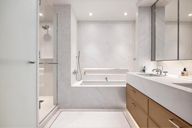 full bath featuring vanity, recessed lighting, walk in shower, and a bath
